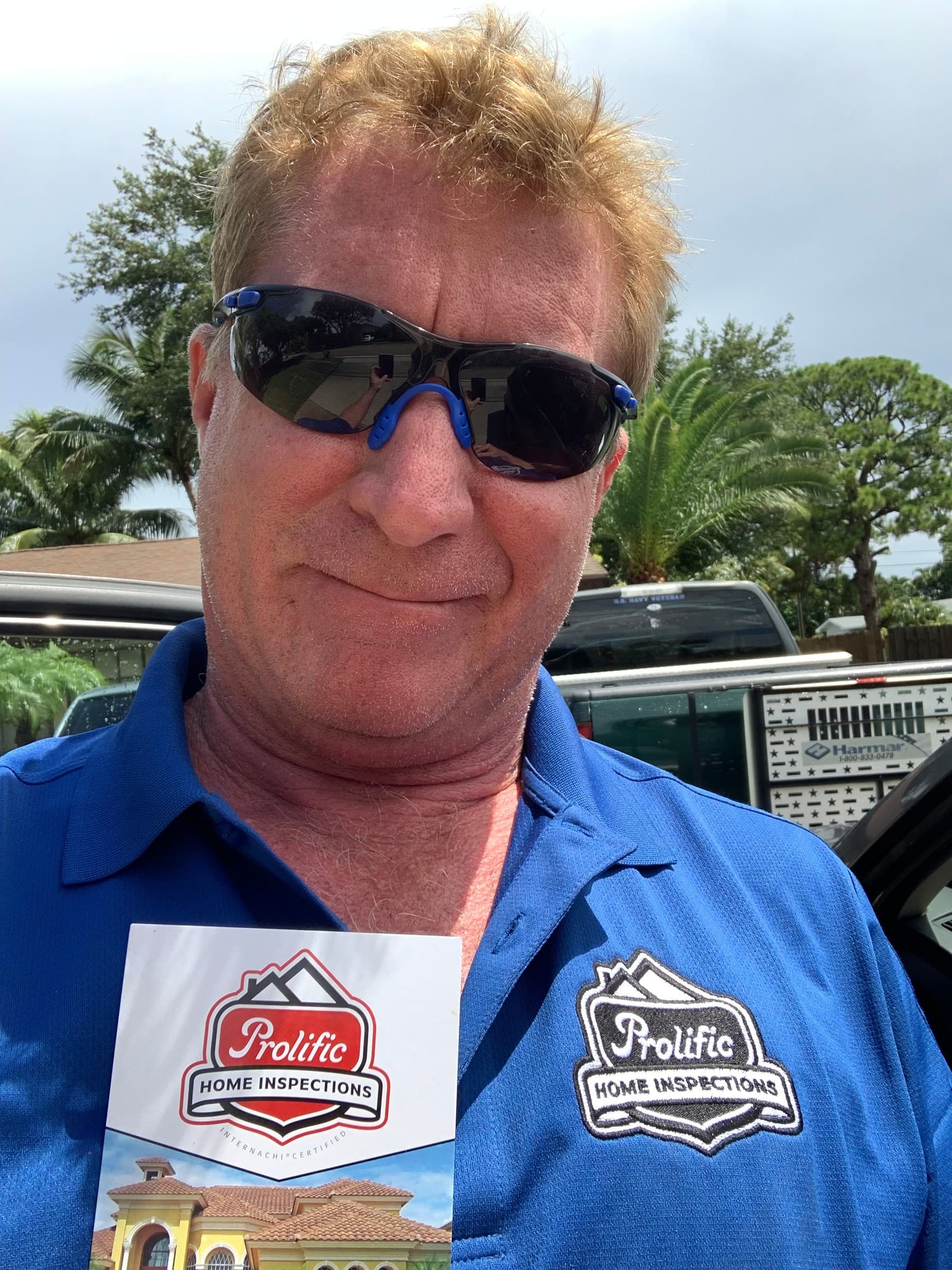 Prolific Home Inspections team member with company branding on site