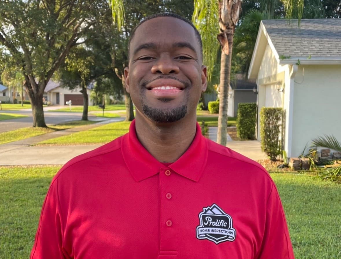 Prolific Home Inspections founder in a red branded polo outdoors